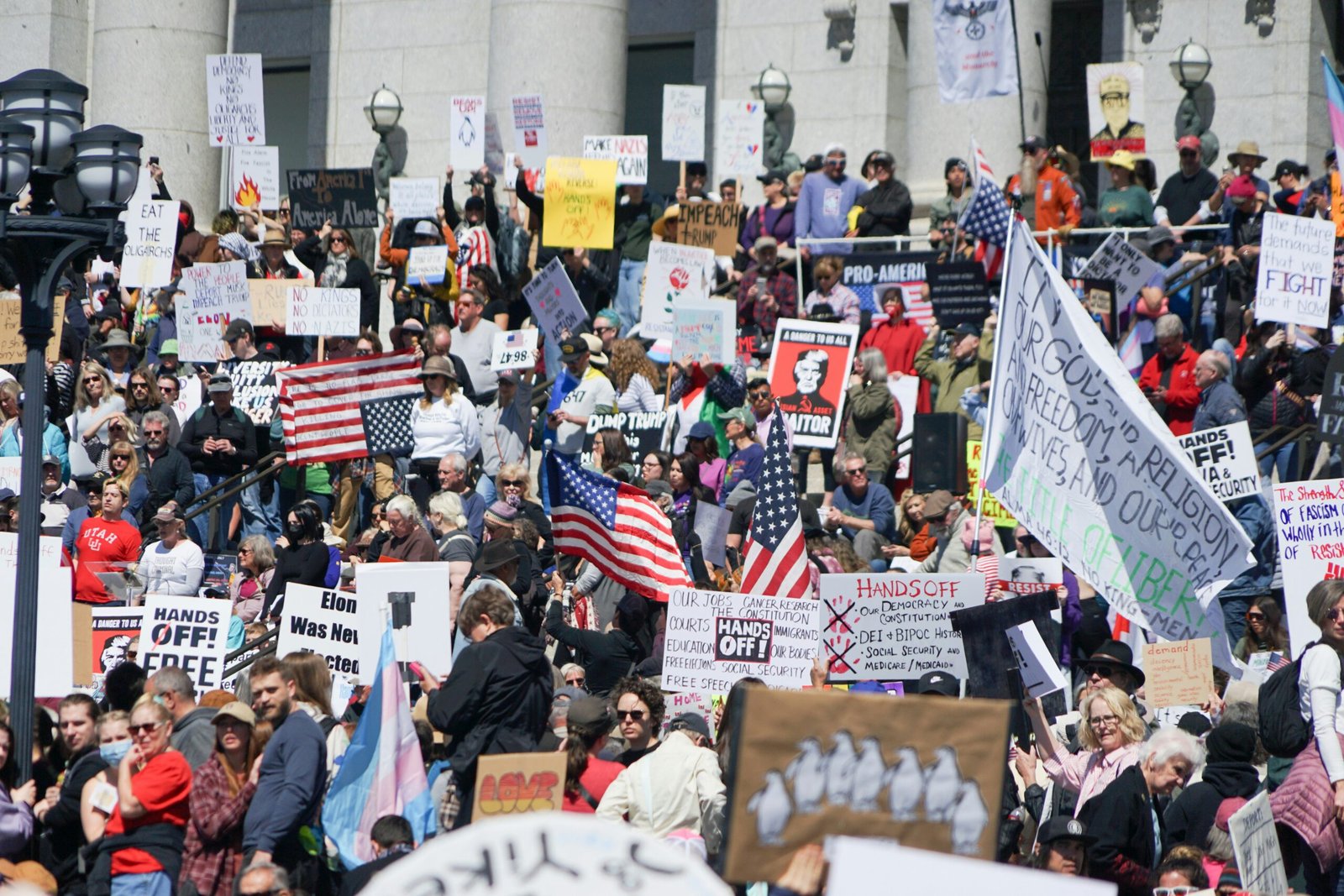 Crowd of protesters holding signs at a demonstration
